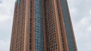 A tall building with a grid-like facade and multiple windows. - Jingkaisi Hotel (Taojialing Subway Station Renxinhui Branch) (Wuhan)