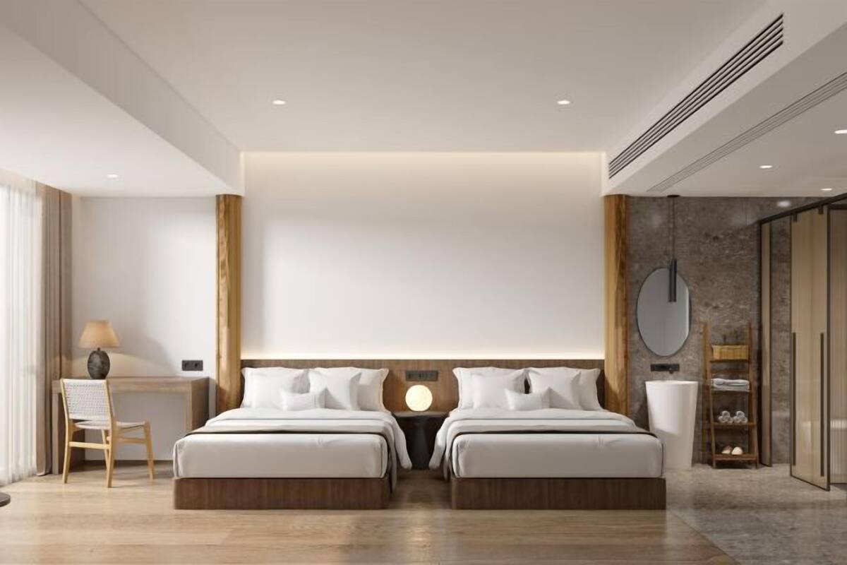 Ein modernes Hotelzimmer mit einem großen Bett, einem Schreibtisch und einem Stuhl.