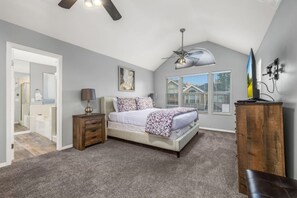 A bedroom with a bed, a nightstand, a dresser, a ceiling fan, and a window with blinds. - Oak Ridge Retreat | Hot Tub | Grill | Spacious (Cottonwood Heights)