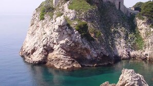 A coastal fortress on a rocky outcrop with clear turquoise waters. - Dubrovnik Cozy central Studio with street View (Dubrovnik)