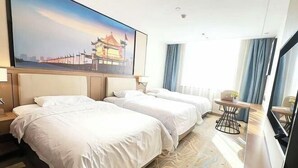 A hotel room with two beds, a large painting of a building, a small table with a chair, and a window with curtains. - Vienna International Hotel (Xi'an Bell and Drum Tower Ximen Airport Bus) (Xi'an)