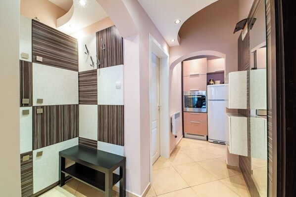 A modern kitchen with built-in appliances and a dining area with a black table.