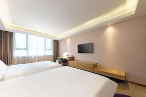 A hotel room with two beds, a desk, a chair, a TV, and a window with curtains. - Lavande Hotels(Shenzhen Fanshen Metro Station&Wanda Plaza ) (Shenzhen)