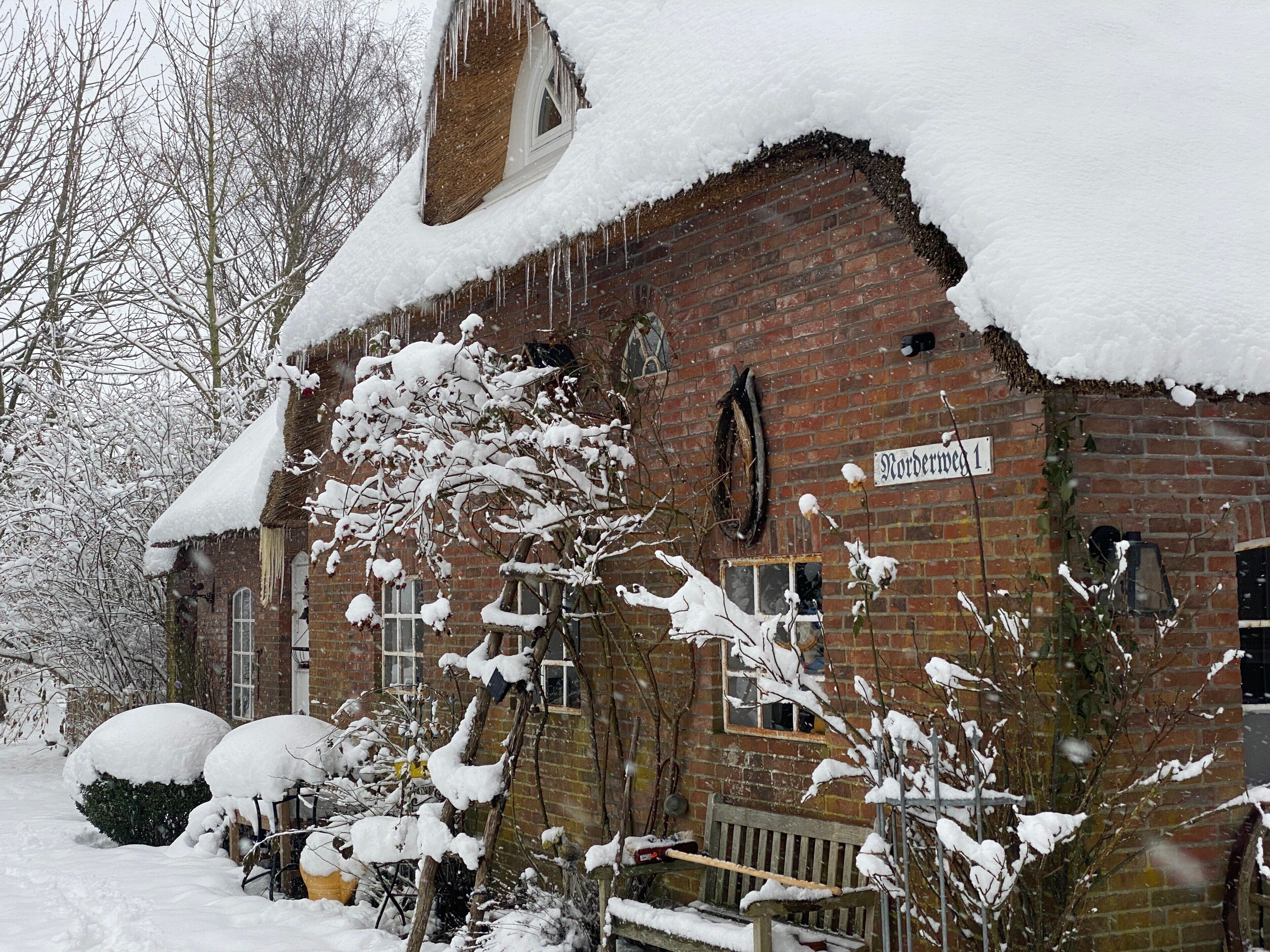 A brick building with snow-covered windows and a sign reading 'Nordermoor 1'.