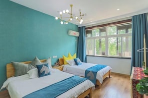 A room with two beds, a ceiling light fixture, a window with curtains, and a table with a plant. - Moshang Huakai Inn (Tongxiang)