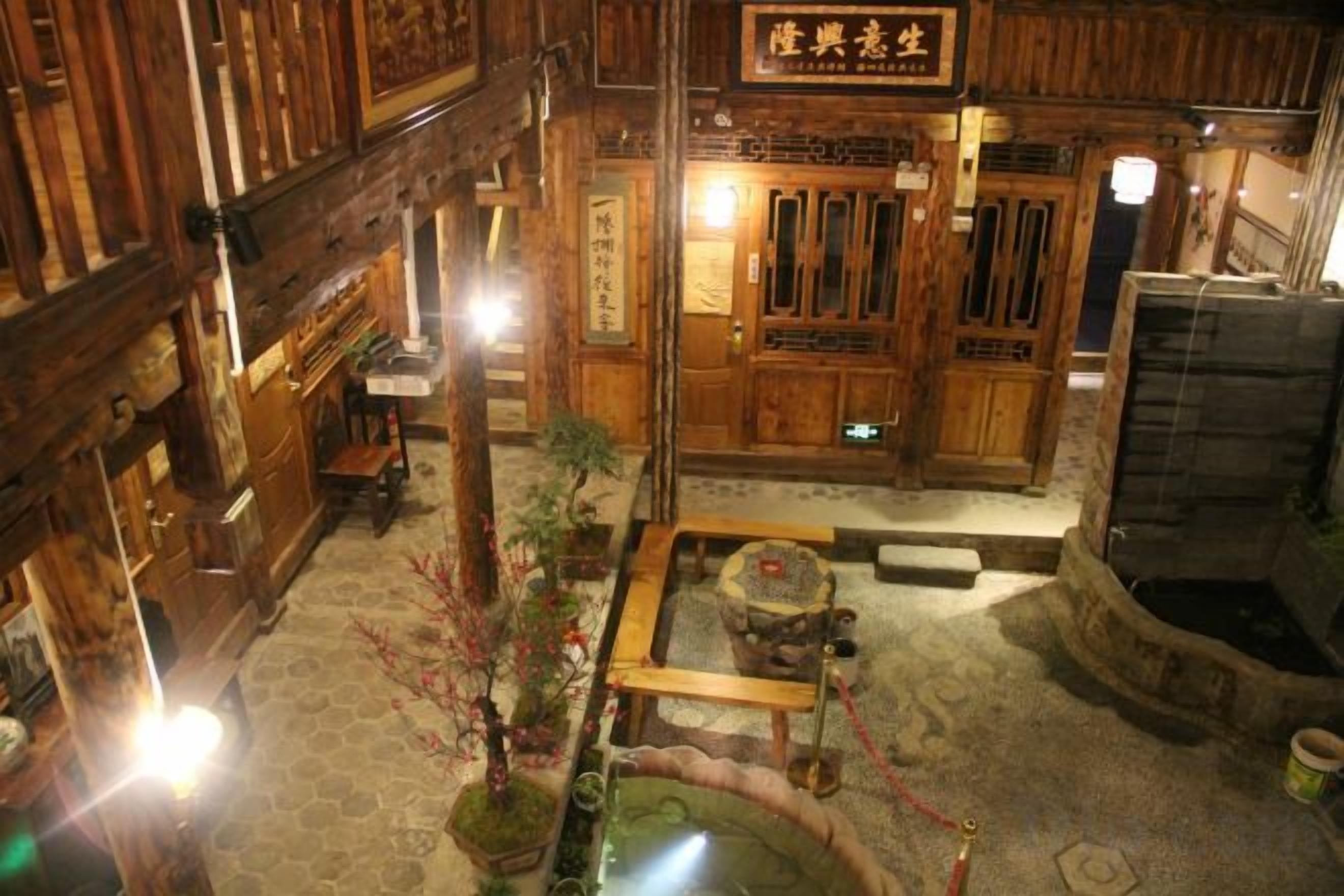 A traditional wooden interior with a reception desk, a wooden counter, and a sign above the door.