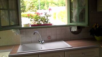 Fridge, microwave, coffee/tea maker, cookware/dishes/utensils