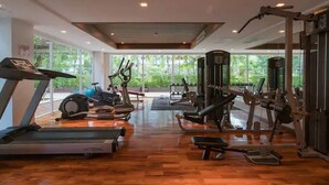 A gym with treadmills, stationary bikes, and weight machines. - 6-17 - 2 Bdr Condo with Balcony and shared Pool (Tambon Patong)