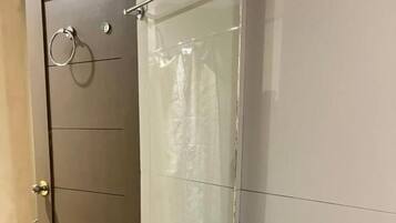 A bathroom with a white sink, a mirror, and a towel rack.
