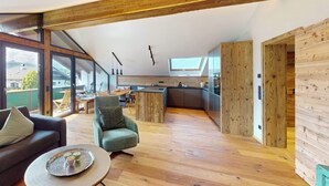 A modern interior with a kitchen, dining area, and living space.