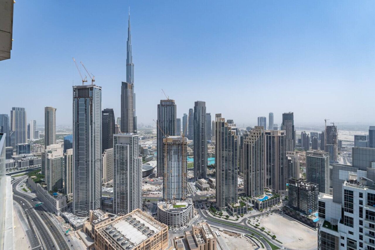 A high-rise urban area with multiple skyscrapers, including a prominent tower under construction.
