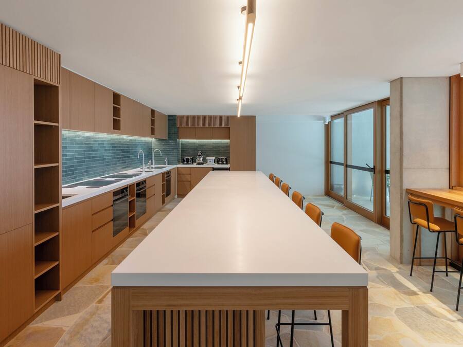 Una cocina moderna con una encimera amplia, armarios empotrados y un ventanal que aporta luz natural.