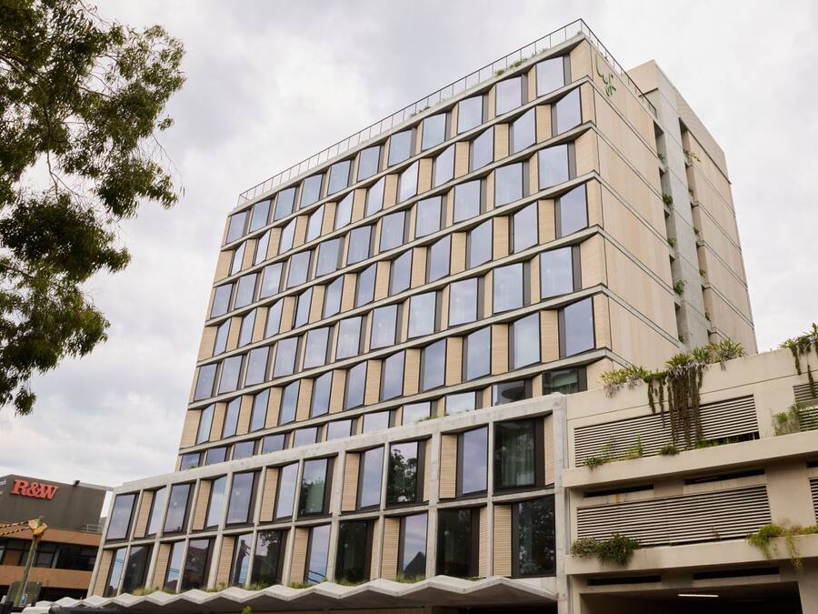 A multi-story building with a grid of windows and a flat roof.