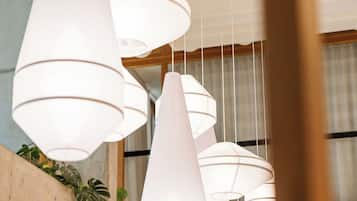 A modern interior with multiple white pendant lights hanging from the ceiling.