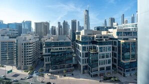 A modern urban area with high-rise buildings, including a distinctive skyscraper. - The Pad 1109 - Business Bay · Cosmopolitan Apartment with Burj Khalifa View (Dubai)
