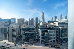 A modern urban area with high-rise buildings, including a distinctive skyscraper. - The Pad 1109 - Business Bay · Cosmopolitan Apartment with Burj Khalifa View (Dubai)