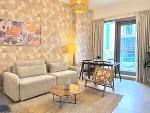 A living room with a sofa, coffee table, and a patterned wall.
