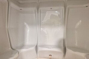 A bathroom with a bathtub, a toilet, and a sink.
