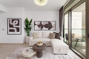 Ein modernes Wohnzimmer mit einem Ecksofa, einem runden Couchtisch und einem großen Fenster mit Blick ins Freie.