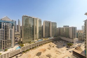 A high-rise residential building complex with multiple apartment buildings, a central courtyard, and a parking area.