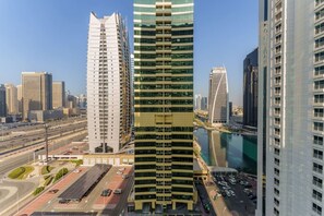 A high-rise building with a modern design, featuring a prominent central tower and a series of smaller surrounding structures.