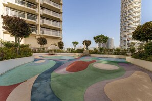 A rooftop with colorful, abstract patterns and a pool.