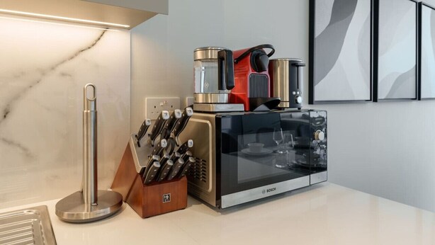 A kitchen with a Bosch oven, a coffee maker, and a knife block. - Beachfront Luxury Living at La Vie Residence JBR (Dubai)
