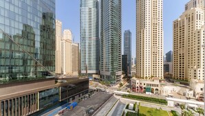 A modern urban area with high-rise buildings, a large parking lot, and a well-maintained green space. - Beachfront Luxury Living at La Vie Residence JBR (Dubai)