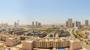 A cityscape with multiple high-rise buildings and a clear sky.
