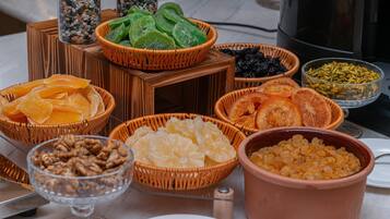 A table with various food items including dried fruits, nuts, and other snacks.