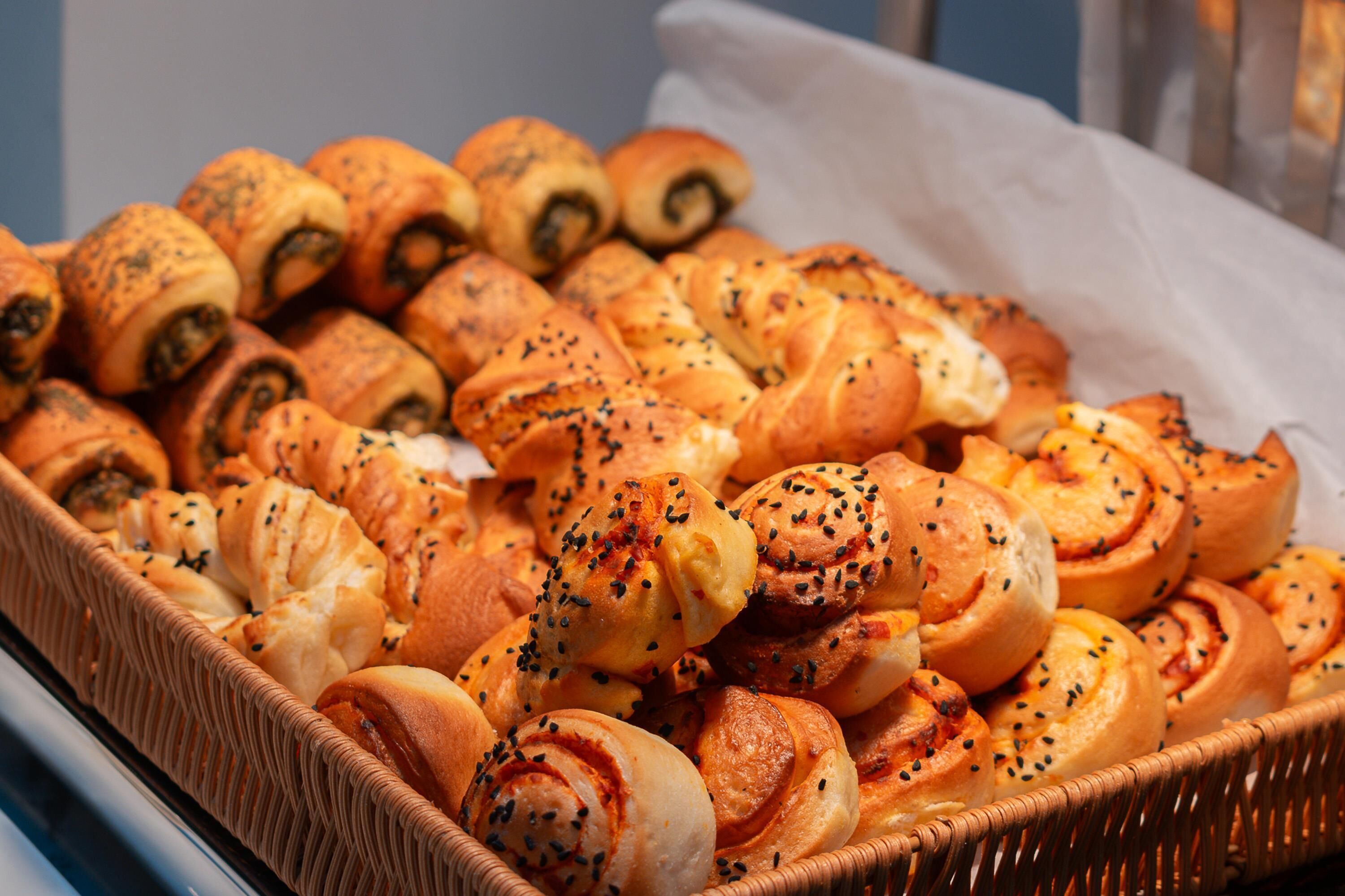 Diverse versgebakken gebakjes in een rieten mand.