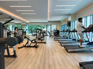 A gym with treadmills, weight machines, and free weights. - Luxurious Living 3 Bedroom at Harbour Views (Dubai)