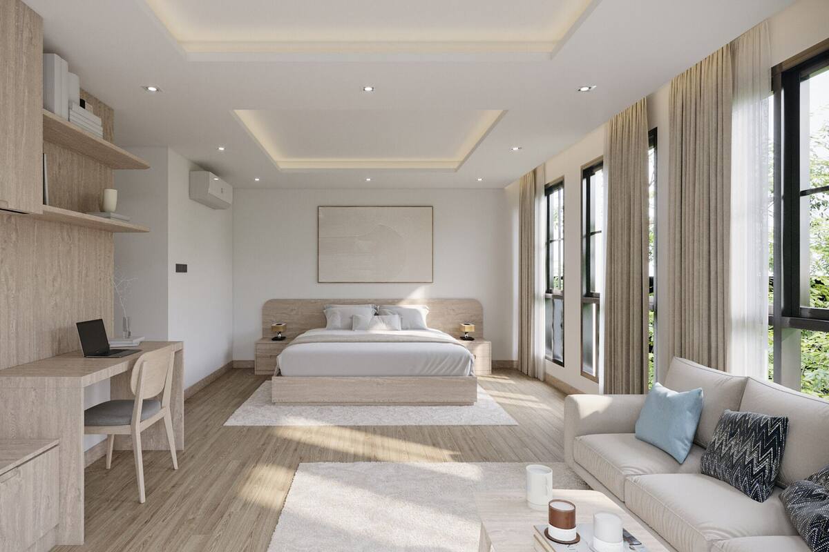 A modern bedroom with a bed, desk, and seating area.
