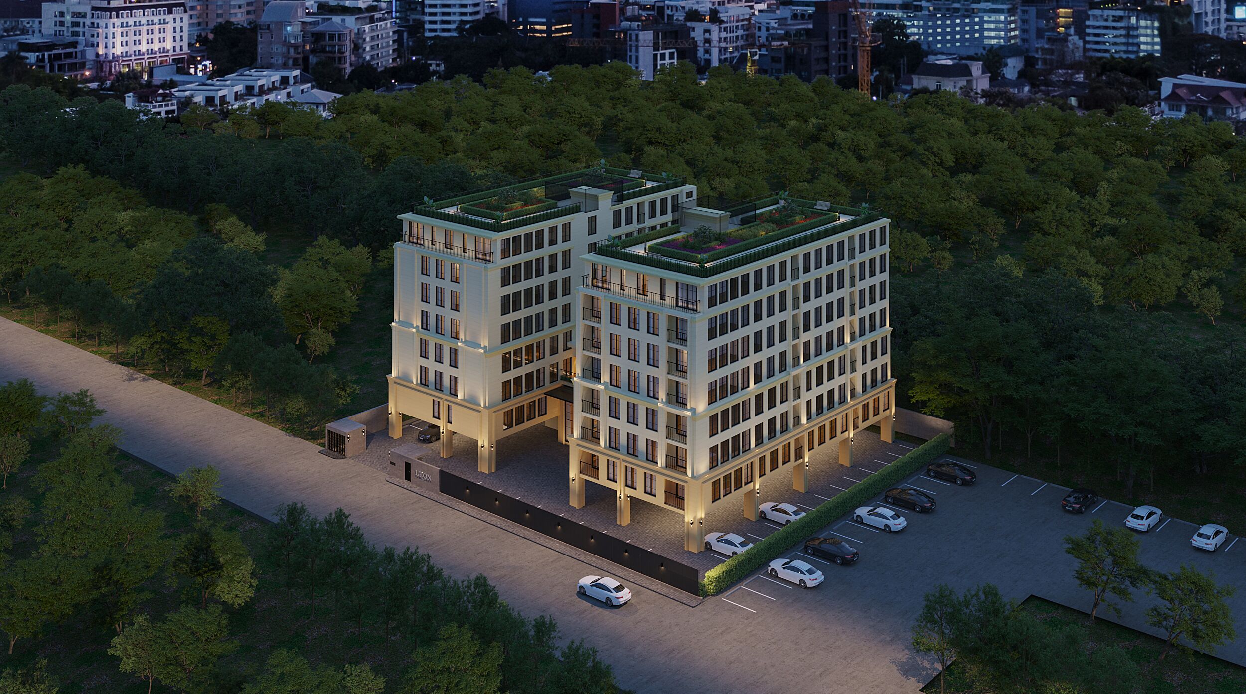 A modern multi-story building with a flat roof, surrounded by trees.