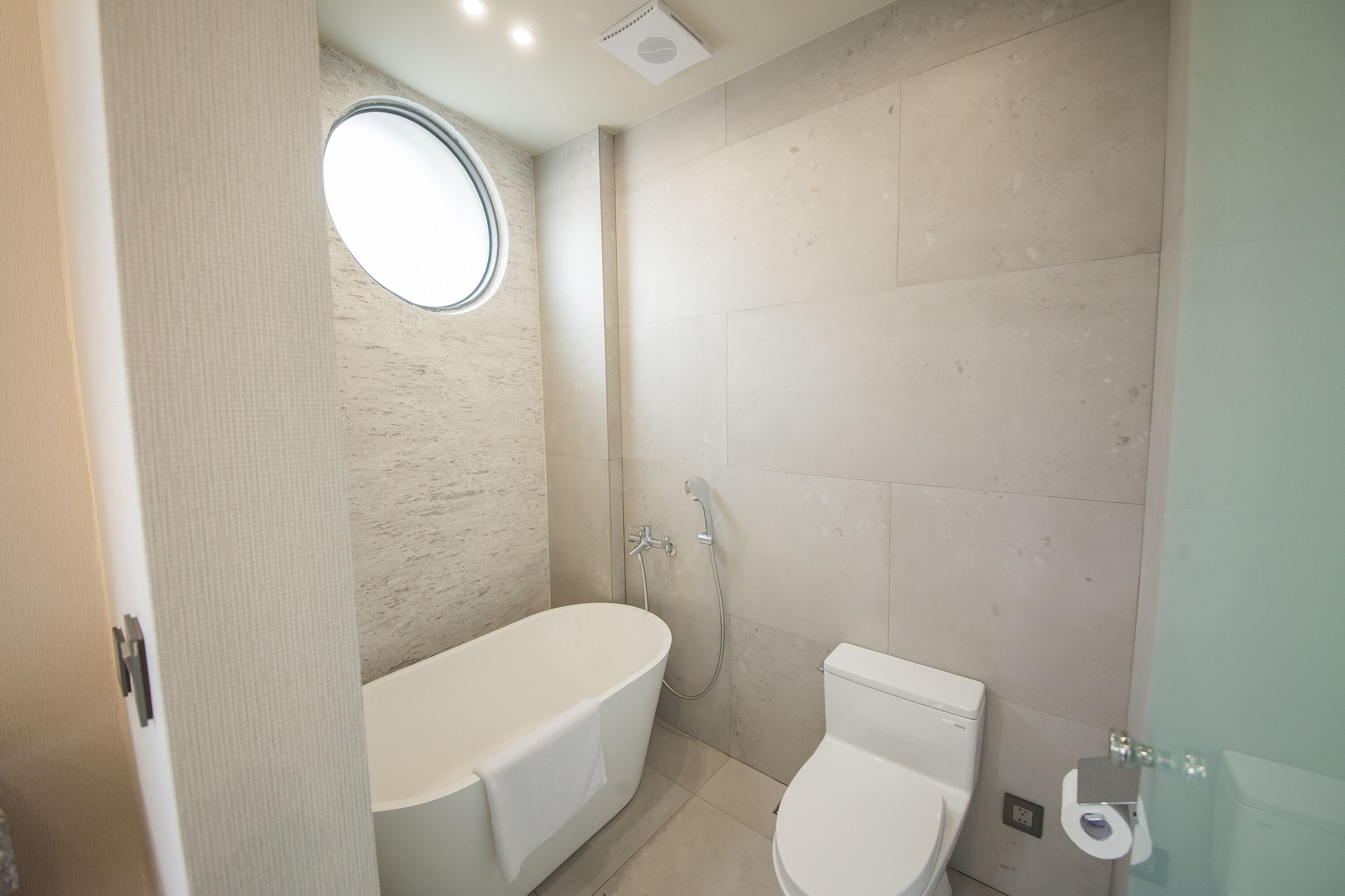 A bathroom with a bathtub, toilet, and a shower.