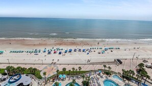 A beach resort with multiple swimming pools, sun loungers, and a sandy beach area. - Horizon Hideaway - Ocean Walk (Daytona Beach)