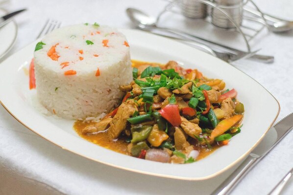 Un plato de comida con arroz y salteado de verduras.