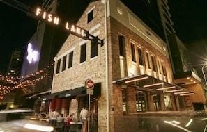 A building with a 'Fish Lane' sign, a 'No Entry' sign, and a restaurant named 'Café'.