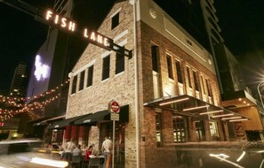 A building with a 'Fish Lane' sign, a 'No Entry' sign, and a restaurant named 'Café'. - 2BR South Brisbane | Free Parking + Walk to QPAC (South Brisbane)