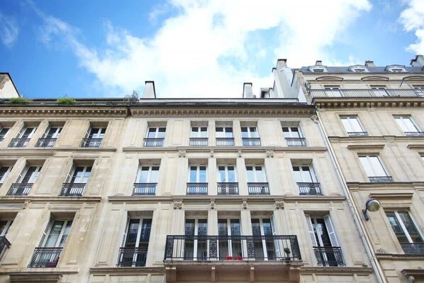 A multi-story building with a classical architectural style, featuring evenly spaced windows and balconies.