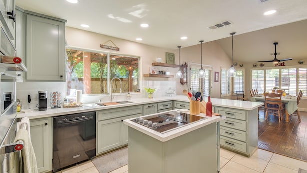 A modern kitchen with a central island, built-in appliances, and ample counter space. - 1 Mi to Applegate Park Zoo: Pet-friendly Home (Merced)