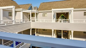 A multi-story residential building with a balcony on the upper floor.
