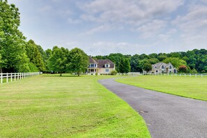 A large, open grassy area with a paved path leading to a house. - Multi-level Group Escape 8 Mi to Ocean City Beach (Berlin)