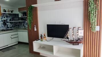 Apartamento família, várias camas | Área de estar | TV de tela plana