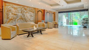 A spacious lobby with a marble floor, a large wall mural, and a seating area with sofas and a coffee table. - Aatmayog Luxury Manor Manali by Blueko Hotels (Manali)