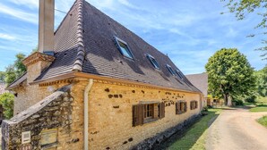 A stone building with a steep gabled roof, a narrow entrance, and a dirt path leading to it. - Villa Le Bos - Three Bedroom Villa, Sleeps 6 (Pezuls)