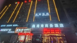 A hotel with illuminated signage and a visible entrance.