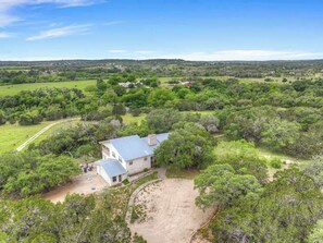 A large, single-story house with a spacious front yard and a driveway leading to the entrance.