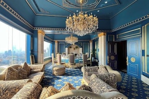 A luxurious room with a city view, a chandelier, and a dining area. - Nanjing Grand Hotel (Nanjing)