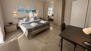 A modern hotel room with a large bed, bedside tables, a desk, and a wardrobe. - Apartment N.3, Appartamento N.3 Primo piano (San Salvatore)